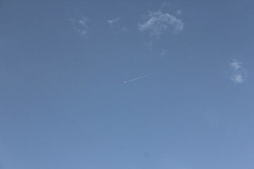 Clear blue sky with a single cloud, symbolizing simplicity, freedom, and openness in a natural setting.