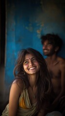 A happy Indian woman smiles warmly next to her partner in a natural, sunlit environment
