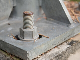 Industrial action close-up of rusty bolt on metal base construction site detailed image urban environment macro perspective
