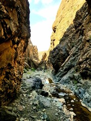 A majestic rock formation in a desert landscape under clear skies, showcasing the timeless beauty and geology of arid regions.