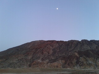 A desert trail leading into the horizon with mountains in the distance, evoking a sense of adventure.