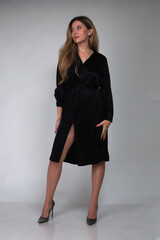 Portrait of a beautiful fashion girl blond in the studio in a nice blue dress