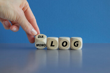 Businessman turns cube and changes the German word Monolog (monologue) to Dialog (dialogue)....