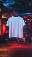 Obraz premium Blank White T-Shirt Hanging in a Dark Club. A clean, crisp white t-shirt hangs on a clothes hanger against a blurred background of a dimly lit club or bar.