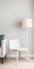 A modern living room featuring a simple white chair and a standing lamp on a light wooden floor