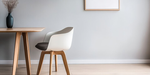 A minimalist dining area featuring a wooden table and a stylish chair in neutral tones