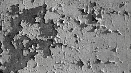 The photo shows an old concrete wall painted with gray paint