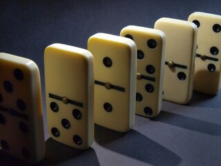 Board game Domino. Bones. The domino principle. Responsibility, collapse and fall. dice