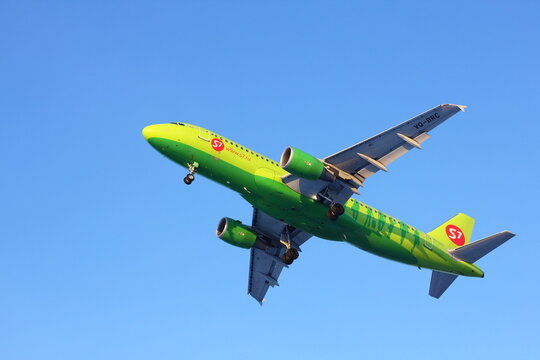 NOVOSIBIRSK - JANUARY 2016: Airbus A320 of S7 airlines approach at Novosibirsk Tolmachevo Airport. Landing in blue sky. 