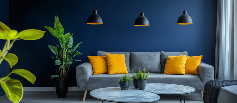 Modern living room with blue walls, gray sofa, and yellow accent pillows
