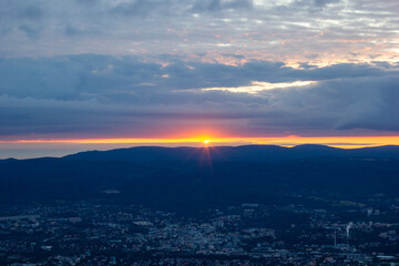 dawn against the backdrop of mountains and a small town