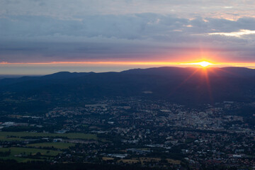 dawn against the backdrop of mountains and a small town