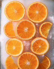 mandarine orange fruit slices on frozen surface