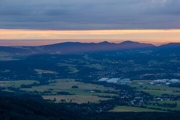 dawn against the backdrop of mountains and a small town