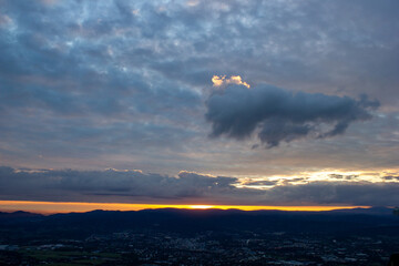 dawn against the backdrop of mountains and a small town