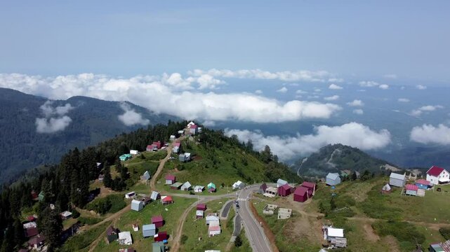 A breathtaking aerial view of Gomis Mta, a village in the mountains of Georgia. The video captures green mountain tops and quaint houses, showcasing the stunning landscape and peaceful rural life.