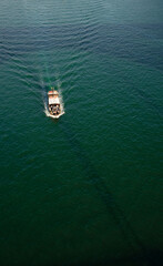 Boat Sailing on Emerald Waters

