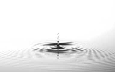 single water droplet creates ripples on calm surface, capturing moment of tranquility and reflection. concentric circles spread outward, symbolizing peace and harmony