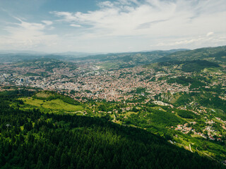 A captivating aerial view of Sarajevo's cityscape nestled amidst the scenic hills of Bosnia and...