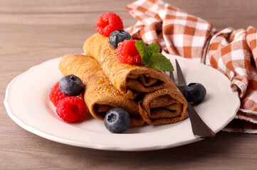 Chocolate crepes with sweet filling,