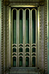 Beautiful forged metal (copper) grille covering heating radiators or a fireplace