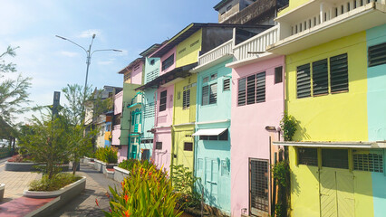Colorful Houses Along a Vibrant Urban Walkway on a Sunny Day
