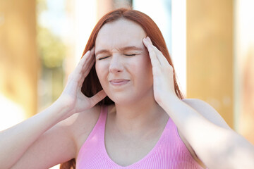 Woman with severe headache presses her temple with her hand