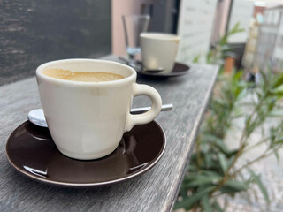 side view cups of coffee on table or windowsill of a cafe