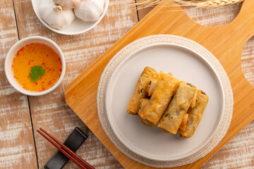 egg rolls,Deep fried Chinese Chives Spring Rolls(Gui Chai) on a white plate.Thai snack food.Top...