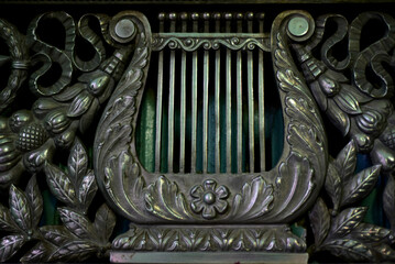 Beautiful forged metal (copper) grille covering heating radiators or a fireplace