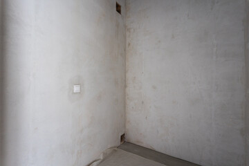 interior of the apartment without decoration in gray colors. rough finish