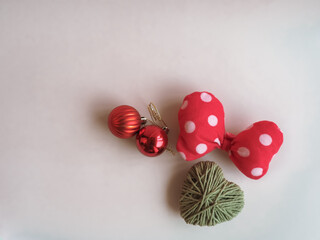 Christmas gifts and decorations on a minimalist pastel pink background.         