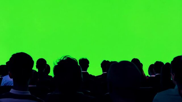 Big crowd or public silhouette watching a performance,sports game or other use. Audience 4k video chroma key copy space on empty green screen