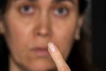 Broken nail on a woman's hand. Close-up of a broken nail on the index finger.