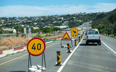 Roadworks at the highway. Warning road signs on the asphalt.