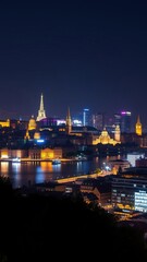 Obraz premium Vibrant city skyline of Europe illuminated at night with iconic landmarks and reflections on the water, night view, Europe