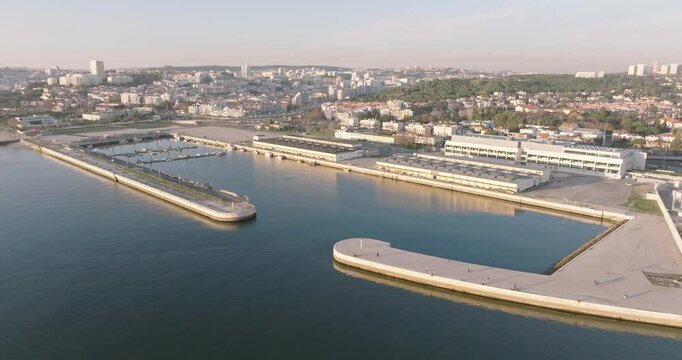 Aerial drone shot of Doca de Pedrou&ccedil;os marina in Belem, Lisbon, Portugal, Europe. Golden hour before sunset. Shot in ProRes 422 HQ