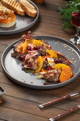 Portion of gourmet beef with pumpkin and beets on wooden table