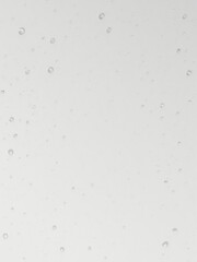 Obraz premium Water drops glisten on a neutral gray backdrop, creating a tranquil and minimalist aesthetic, water, gray background