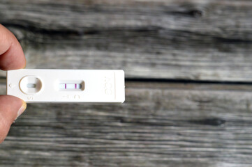 A Positive result of rapid urine pregnancy test, detecting human chorionic gonadotropin HCG in...