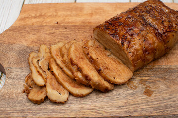 Seitan: vegan meat alternative made of washed flour gluten spices. Roasted and served on wooden board