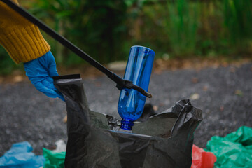 Two Asian women are collecting garbage, working together to clean the environment. They are focused on waste segregation, promoting recycling, and contributing to a cleaner
