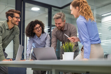 Business team discussing together business plans in office.