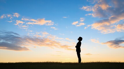 A silhouette of a person against a vibrant sunset sky, reflecting upon life.