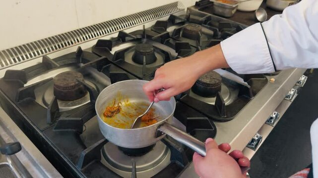 Chef is cooking polenta in a restaurant kitchen