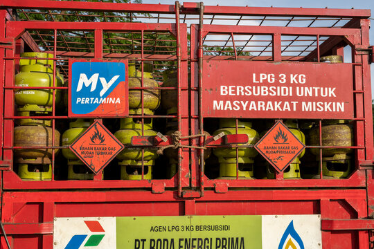 A row of Pertamina LPG gas cylinders neatly arranged on a truck, ready for distribution. december 22,2024 in padang,indonesia