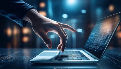 A hand hovers over a laptop keyboard in a darkened room, with a glowing, abstract digital display on the screen.