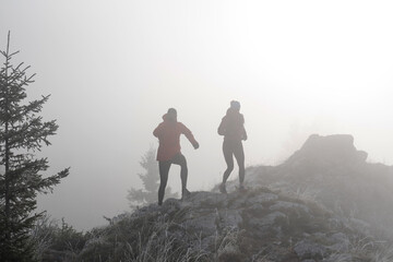 Obraz premium trail running couple man and woman running on a mountain path