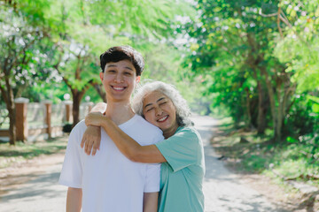 Fototapeta premium An Asian mother and daughter share a heartfelt moment, expressing their love through a warm hug. Their bond is filled with affection, care, and mutual respect, showcasing deep familial connection 