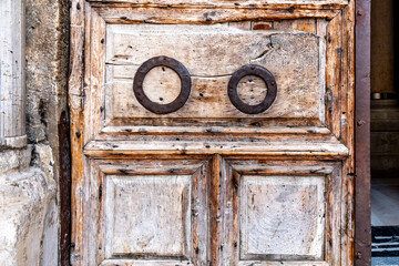 Detail on the wooden doorway at the entrance to the Church of the Holy Sepulchre in Jerusalem